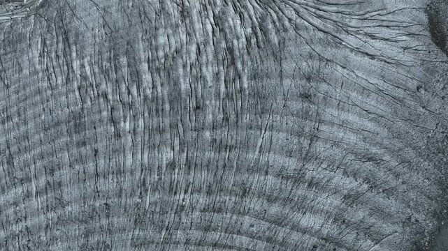 Aerial view of the imposing, textured glacier, a frozen river of ice, showcasing nature's raw power, Chiesa in Valmalenco, Lombardy, Italy.