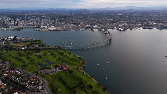 Aerial view of Coronado Bridge spans across the bay, connecting Coronado Island with San Diego, a blend of urban cityscape and serene waters, Coronado, California, United States.