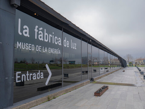 Ponferrada, Leon, Spain; 01-18-2026: Text indicating: "the light factory, energy museum, entrance", located on the glass panel at the top of the museum indicating the direction of the entrance