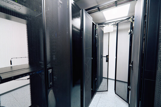 Empty server room aisle with open racks and network equipment in a modern data center