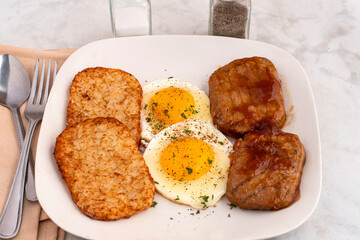 frried eggs  with hash brown and salisbury steak