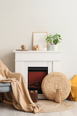 Naklejka premium Old book on armchair near fireplace in living room