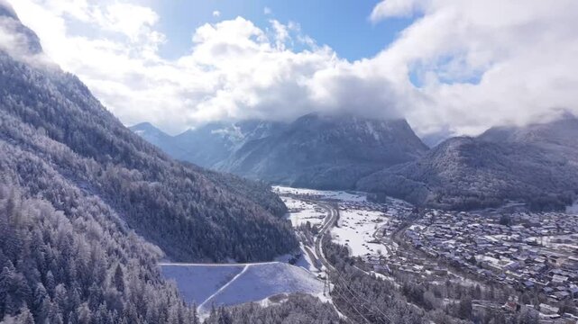 Westliche Karwendelspitze summit. Drone video of the rocky peak in winter. Majestaetischer Gipfel der Karwendelkette in Bayern. Panoramic view of the snow-covered Isar valley and Mittenwald.