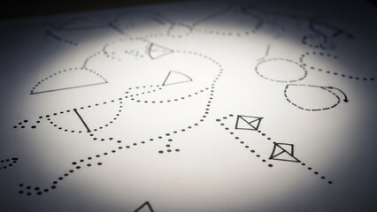 Fototapeta premium Geometric shapes and dotted lines sketch on white paper, illuminated by a spotlight