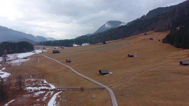 Drone flight over frozen Geroldsee in winter. Located in Kruen Bavaria. Wagenbruchsee is popular tourism destination known for its stunning alpine scenery. Luftaufnahme vom Wagenbruechsee in Krun