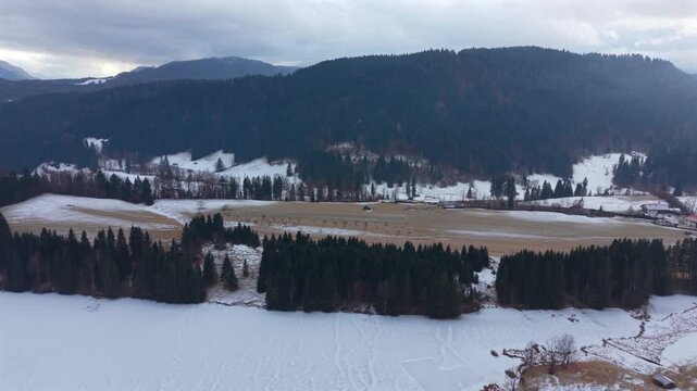 Minimalistic winter aerial of Geroldsee Wagenbruchsee in Kruen Germany. A snow-covered lake in the Alps. One of the most popular and scenic travel spots in Upper Bavaria.
