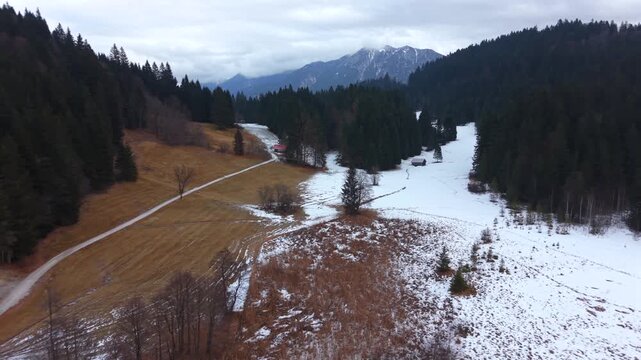 Drone perspective of the frozen Geroldsee in Kruen Germany. Wagenbruchsee is a legendary spot in the Bavarian Alps. Snow-covered landscape in a top-tier tourism region.