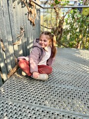 A little girl sitting on the floor