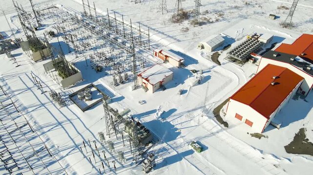 Modern high voltage substation with transformers and battery storage operating in harsh winter conditions, symbolizing energy infrastructure resilience.