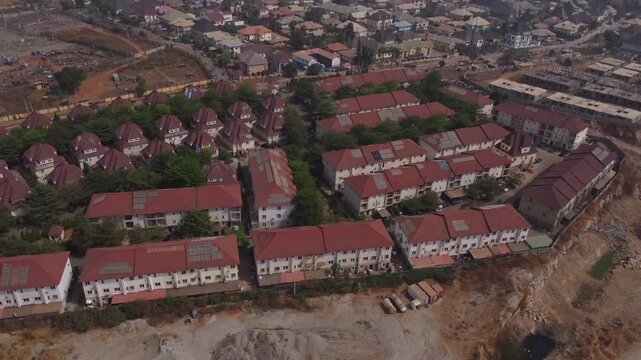 High angle view of a peaceful suburban neighborhood with green trees standing in between rows of houses in Abuja, Nigeria