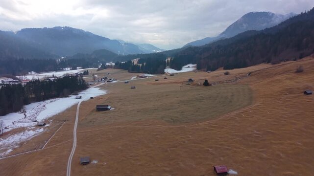 Frozen Wagenbruchsee aerial shot in Kruen. This snowy Geroldsee is a legendary tourist destination in the Bavarian Alps offering stunning winter views and hiking trails.