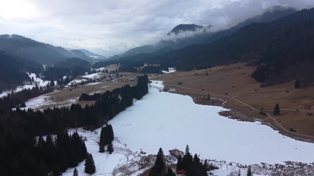 Drone shot of snow-covered Geroldsee, also known as Wagenbruchsee. Located in the Kruen region of Upper Bavaria. An iconic alpine winter destination for hikers and travelers