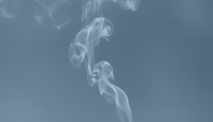 Fototapeta premium Elegant white smoke rising gracefully, creating abstract patterns and ethereal wisps against a serene background