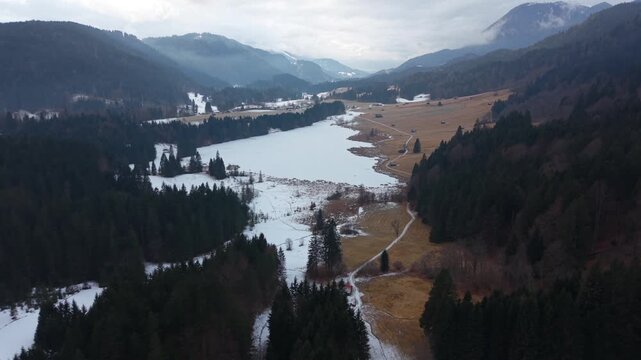 Snowy Geroldsee Wagenbruchsee drone video. Located in Kruen Bavaria. A picturesque and popular winter destination in the Alps featuring pristine snow and mountain views.