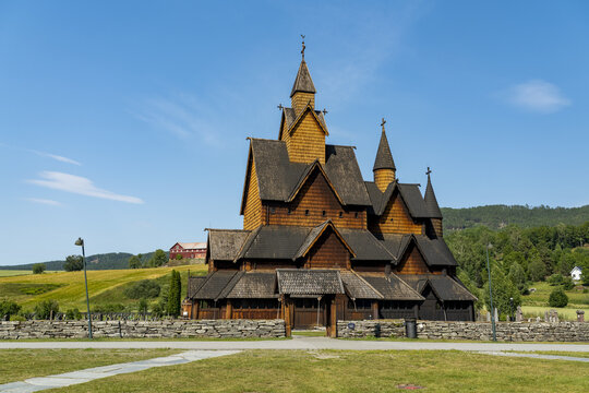 View of the Heddal Stave Church, a wooden marvel against the vibrant blue sky, showcasing Norway's rich architectural heritage, Heddal, Telemark, Norway.