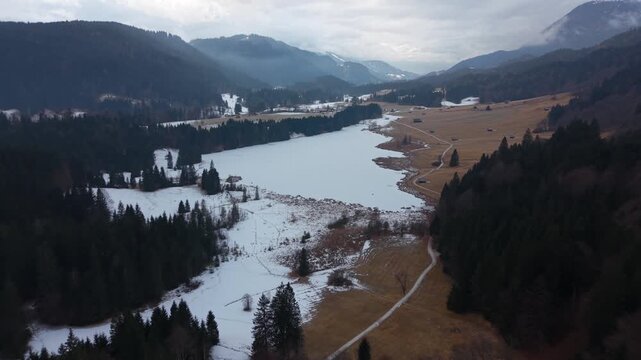 Birds eye view of the snow-covered Wagenbruchsee in Kruen. Geroldsee is a top travel destination in Germany. Perfect winter atmosphere in the Bavarian alpine landscape.