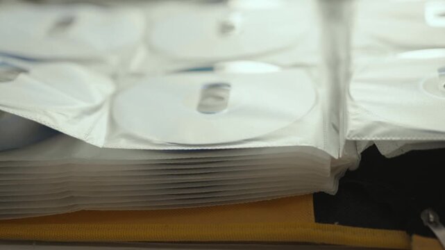 Collection of DVD and CD discs stored in a folder.