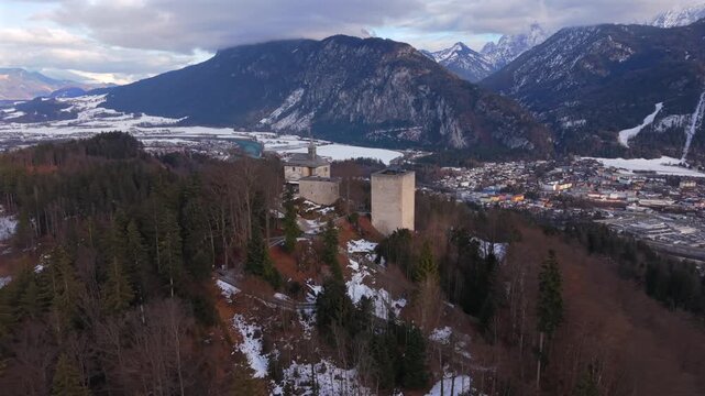 Winter drone footage of Ruine Thierberg between Kiefersfelden and Kufstein, Austria. Historic hilltop fortress overlooking the Inn River, Inntal valley and the alpine peaks of the Kaisergebirge.