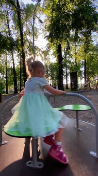 girls ride the carousel in the park