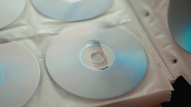 Collection of DVD and CD discs stored in a folder.