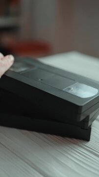 Stack of vintage VHS video cassettes with blank labels. Old analog media technology from 80s and 90s.