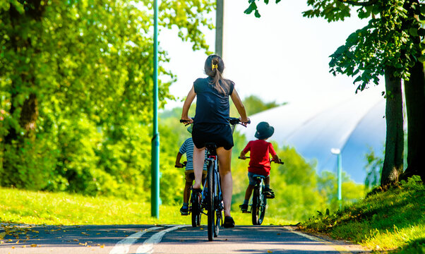 Cyclists ride on the bike path in the city Park
