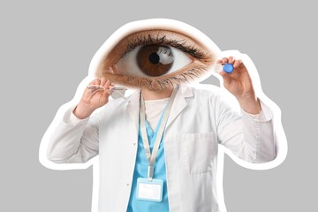 Male ophthalmologist with big eye instead of head, eyeglasses and contact lenses on grey background