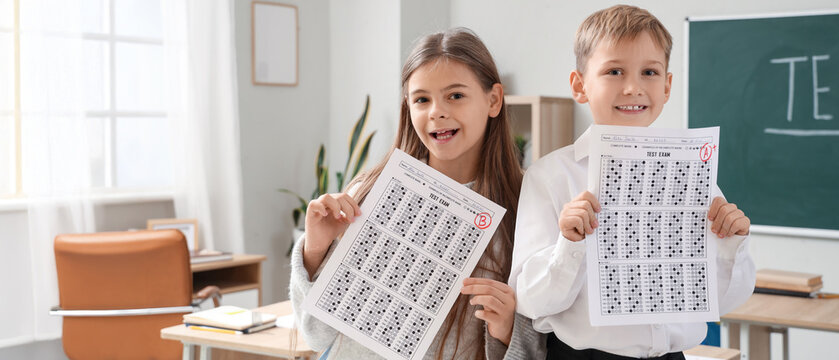Happy pupils with results of test in classroom