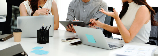 Close up shot business people team meeting in conference room in company. Businessman pointing pen at tablet on the table © Stella 16