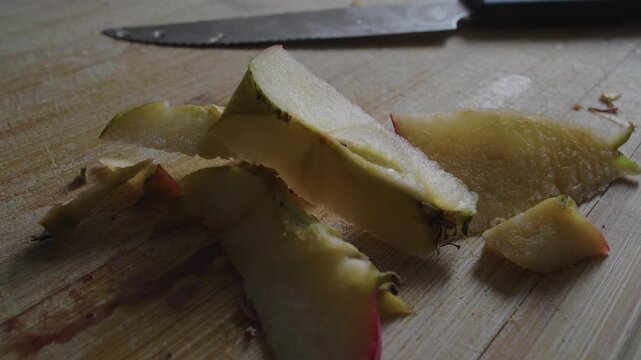 Macro View of Fresh Apple Core and Juicy Slices on Wooden Cutting Board Highlighting Natural Texture, Healthy Ingredients and Simple Kitchen Routine