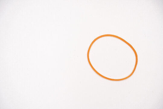 Circular Orange Rubber Bands Arrangement on White Background