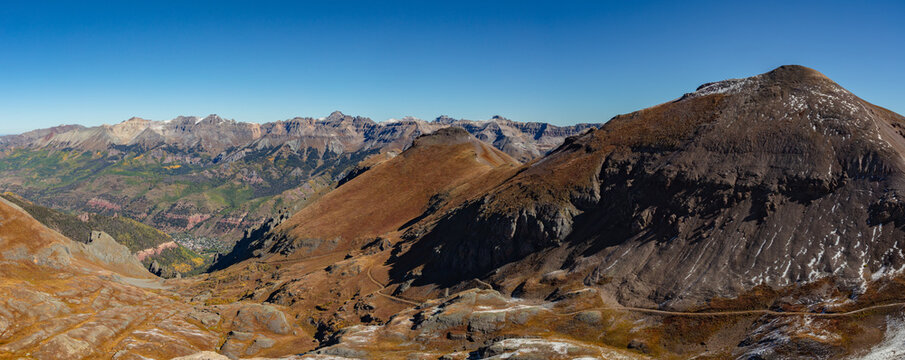 Rising directly above the scenic mountain town of Telluride, Colorado, in this colorful autumn San Juan Mountain panorama are 13ers Jackass Point and La Junta Peak.