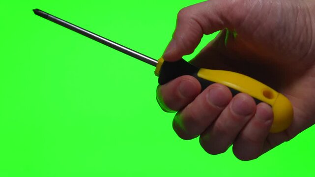 A yellow screwdriver in a hand against a green background.
A steel industrial tool.
A Phillips-head screwdriver in a hand.
