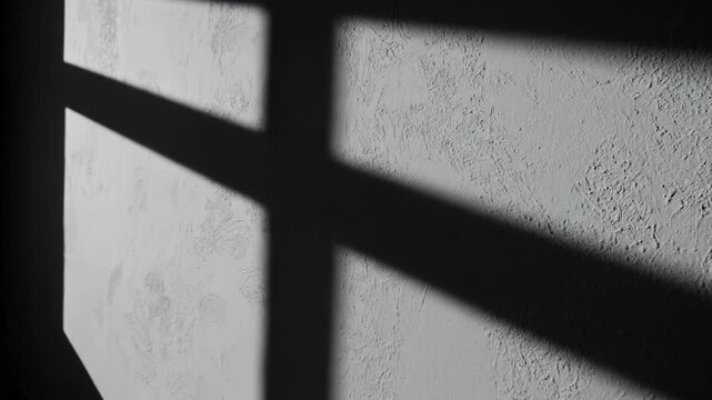 Long angular shadows on wall. Hard side light producing long sharp-edged shadows for strong graphic and editorial backgrounds