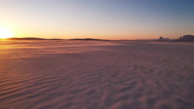 Desert sediment basin. Quiet remote desert basin with pale sandy sediments and shallow wind-shaped ripples under soft evening light