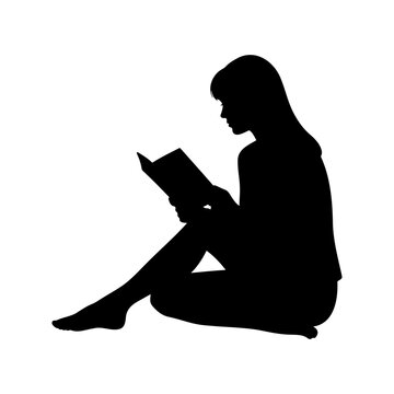 Side view silhouette of a young woman sitting on the floor and reading a book