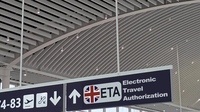 Signage in a United Kingdom airport indicating the new ETA electronic travel authorization system for visa exempt foreign nationals, guiding passengers through immigration and border control
