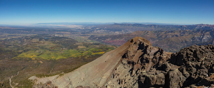Aspen trees below Colorado 13er Corbett Ridge are starting to show signs of autumn color in this panorama captured from Whitehouse Mountain near Ouray, Colorado.