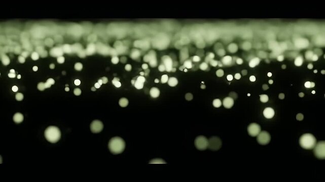 Blurred olive green lights in darkness, creating a bokeh effect