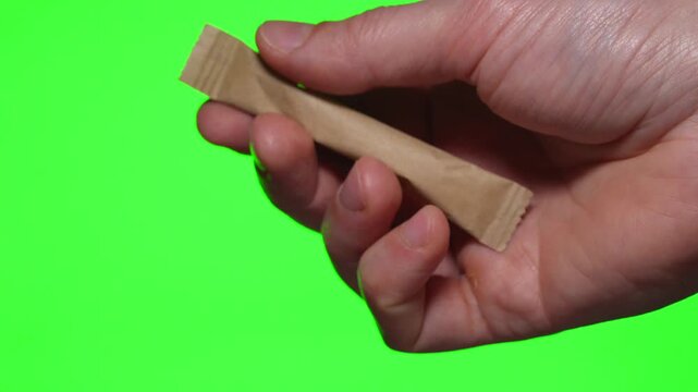 A paper stick of sugar.
5g sugar package in a paper wrapper.
A serving of loose sugar