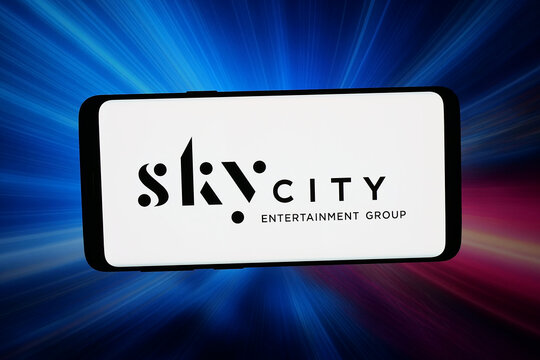 Stuttgart, Germany - 02-27-2026: In this photo illustration, the logo of company SkyCity Entertainment Group Limited is displayed on a smartphone in front of abstract background on computer screen.