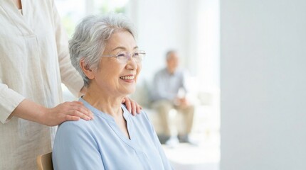 Obraz premium Smiling elderly woman receiving gentle shoulder massage from caregiver in bright home setting, warm affectionate moment conveying comfort and companionship