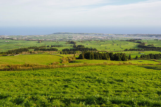 Coast of Terceira Island, Azores, Portugal. Cloudy day and beautiful rural landscape, green Achada Plain valley, Serra do Cume. Agricultural fields and pastures.