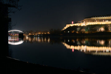 Fototapeta premium Petrovaradin Fortress at night with reflection in Danube river, Novi Sad, Serbia.