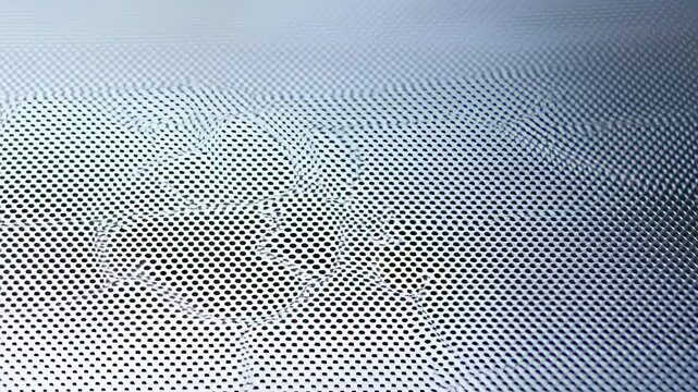 Abstract close-up of a textured metallic surface with perforated patterns. Represents modern design and industrial aesthetics in architecture and product design