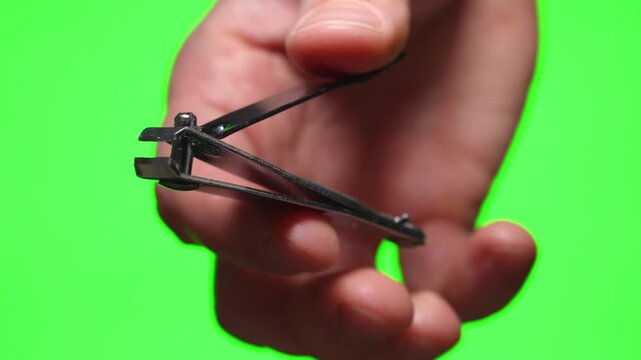 Manicure nippers in hand on isolated background