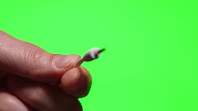 3.5 mm audio cable on a green background.
Mini jack cable