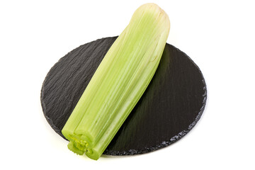 Fresh Celery stalk on black slate, isolated on white background