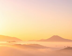 Serene Sunrise Over Mountains with Mist and Soft Clouds