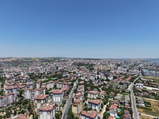 Obraz premium Aerial Panoramic View of Coastal Residential Neighborhood and Blue Sea Horizon